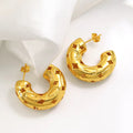 Gold-plated chunky hoop earrings with geometric star cutout pattern and curved design