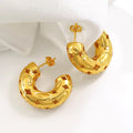 Gold-plated chunky hoop earrings with geometric star cutout pattern and curved design