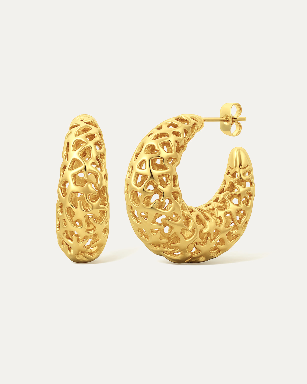 Gold hoop earrings with intricate design on a light beige background