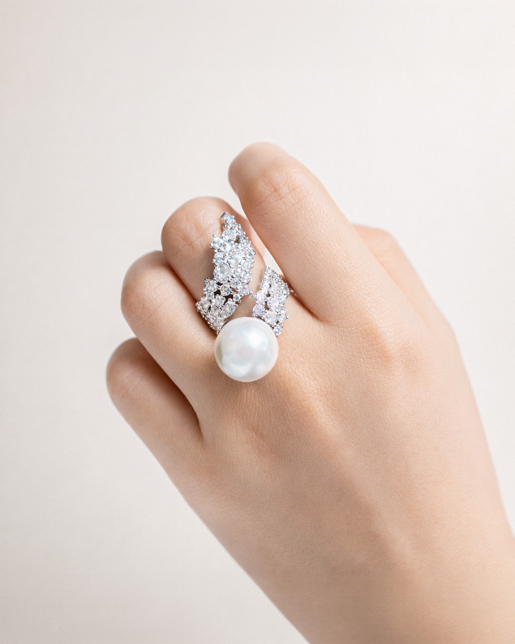 Silver pearl open ring with cubic zirconia on hand, silver-plated brass