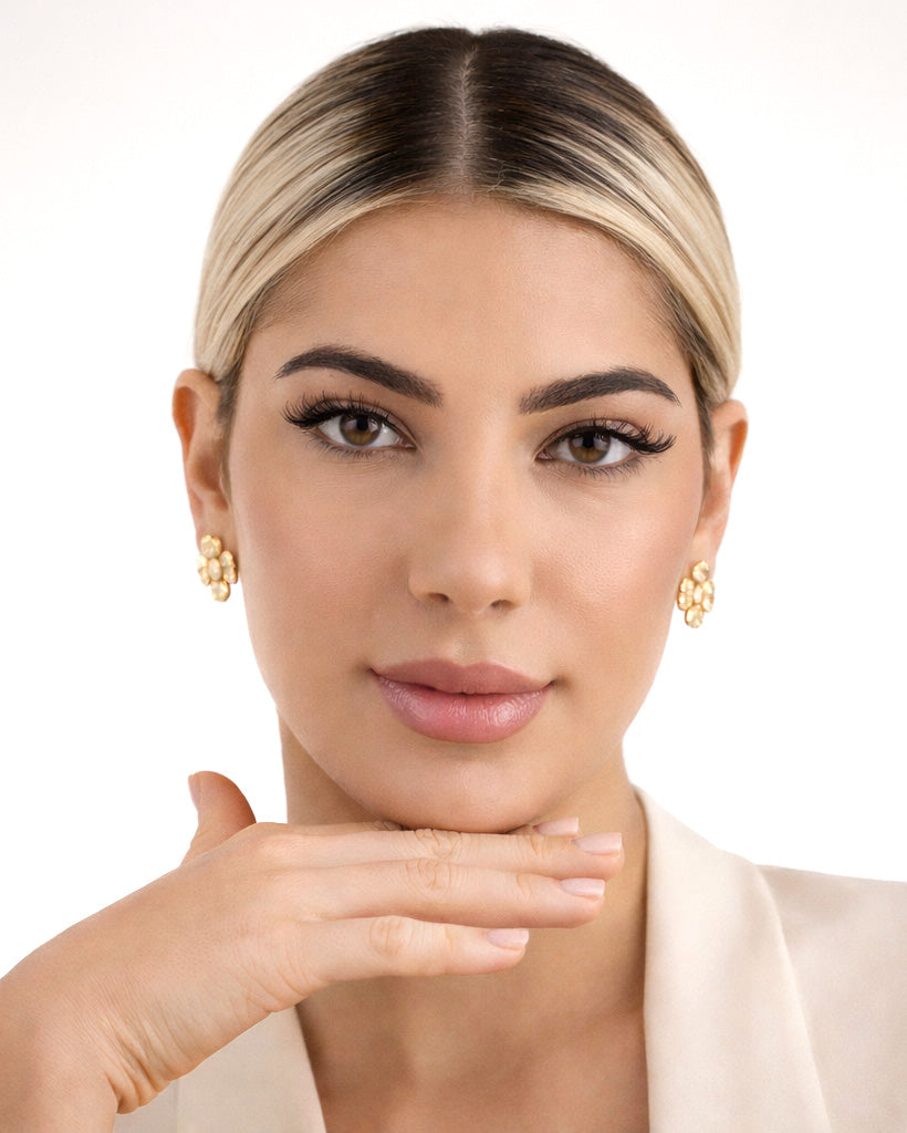 Model wearing 18K gold-plated textured daisy stud earrings, minimalist style