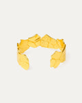 Gold bracelet with geometric design on a light gray background