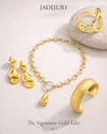 Gold jewelry set including earrings, bracelet, and ring on a light background with 'JADEJURI' branding.