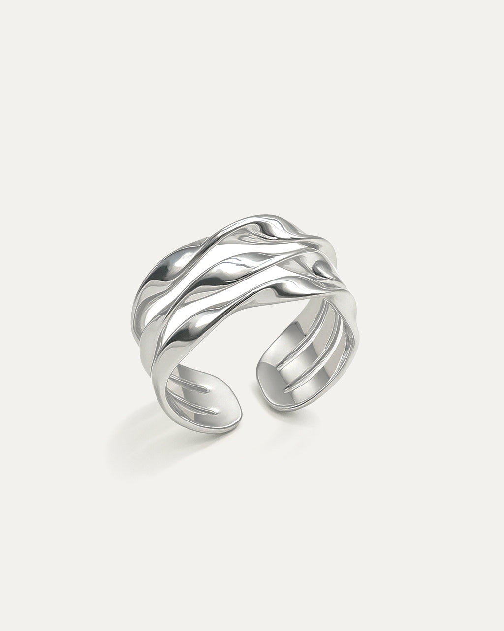 Silver open ring with wavy design on a light gray background