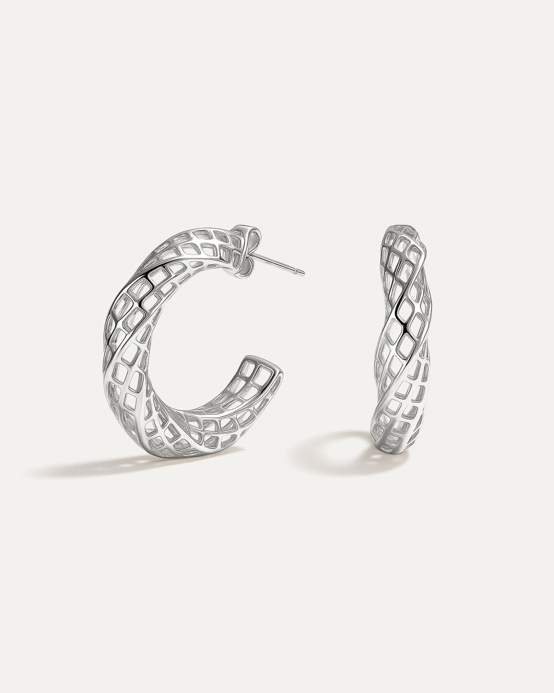 Pair of silver hoop earrings on a white background