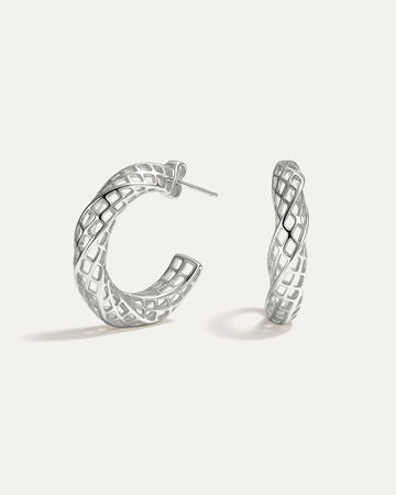 Pair of silver hoop earrings on a white background