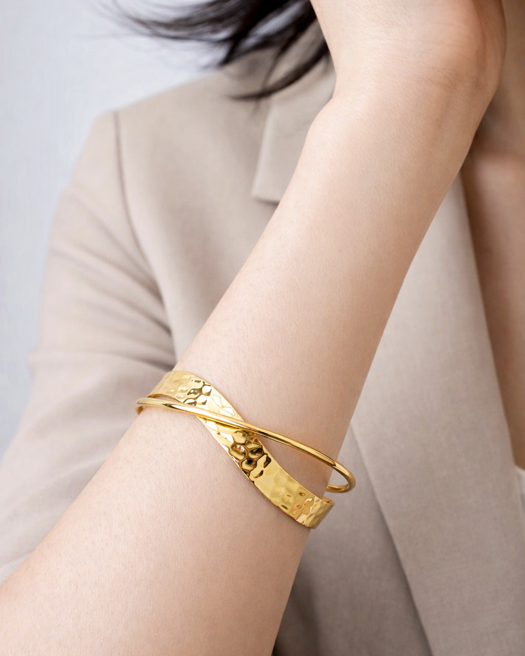 18K gold-plated hammered crossover cuff bracelet worn on wrist, minimalist jewelry