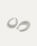 Silver hoop earrings on a light gray background