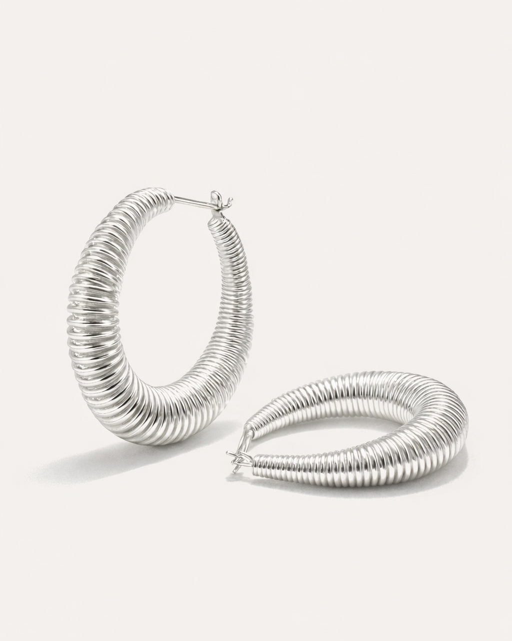 Silver-plated twisted oval spring hoop earrings with coiled design