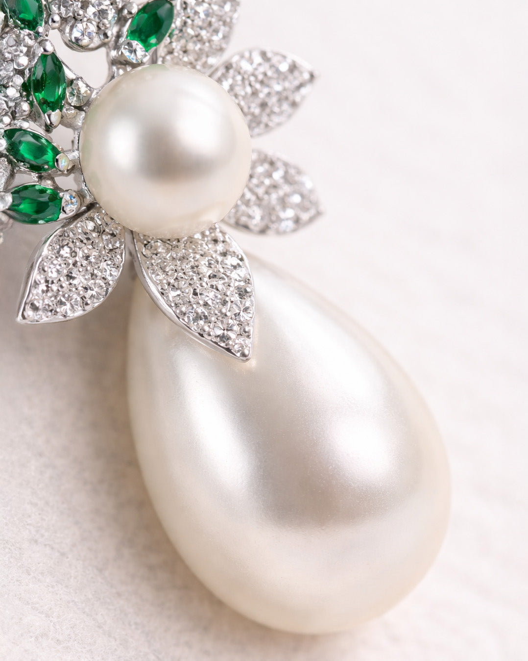 Pearl leaf drop earrings with green zircon close up silver plated detail view