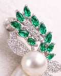 Green zircon pearl leaf drop earrings close up in silver plated setting detail