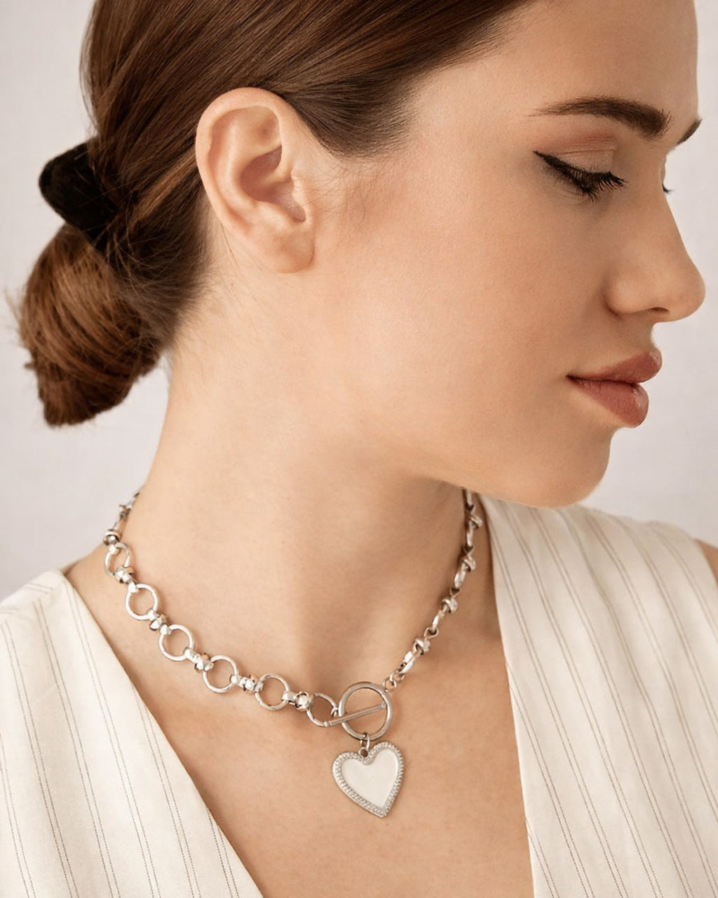 Silver-plated white heart toggle choker necklace on model, minimalist modern jewelry
