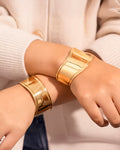 Wide gold cuff bracelet with sculptural design and glossy finish – Jadejuri