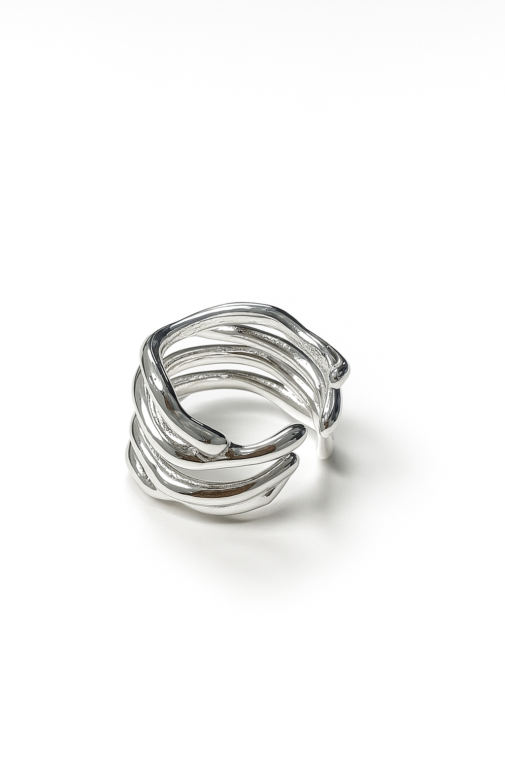 organic open silver ring with sculptural branch-like design on white studio background