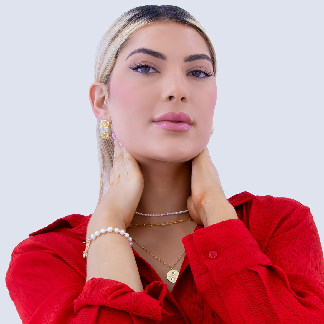 Gold-plated textured stud earrings with braided rope pattern and crystal-embedded center band