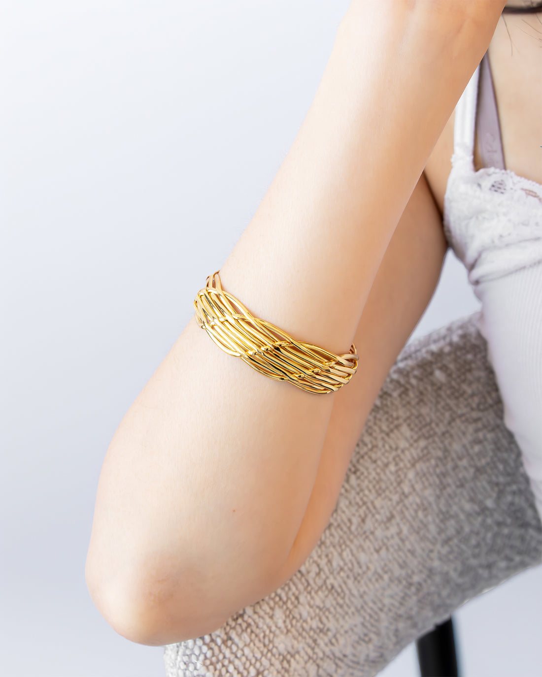 Gold statement bracelet with woven openwork design on wrist – Jadejuri