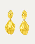 Gold earrings on a light gray background