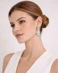 Model wearing abstract silver dangle earrings with sculptural organic design