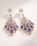 Amethyst cascade gold drop earrings with purple zirconia flat lay elegant design