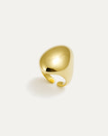 Gold statement ring with bold sculptural curved surface