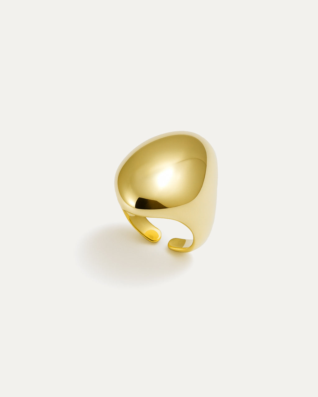 Gold statement ring with bold sculptural curved surface