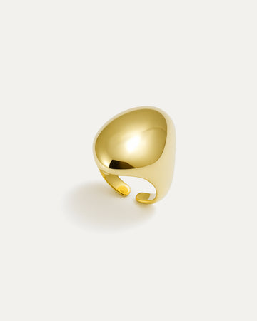 Gold statement ring with bold sculptural curved surface