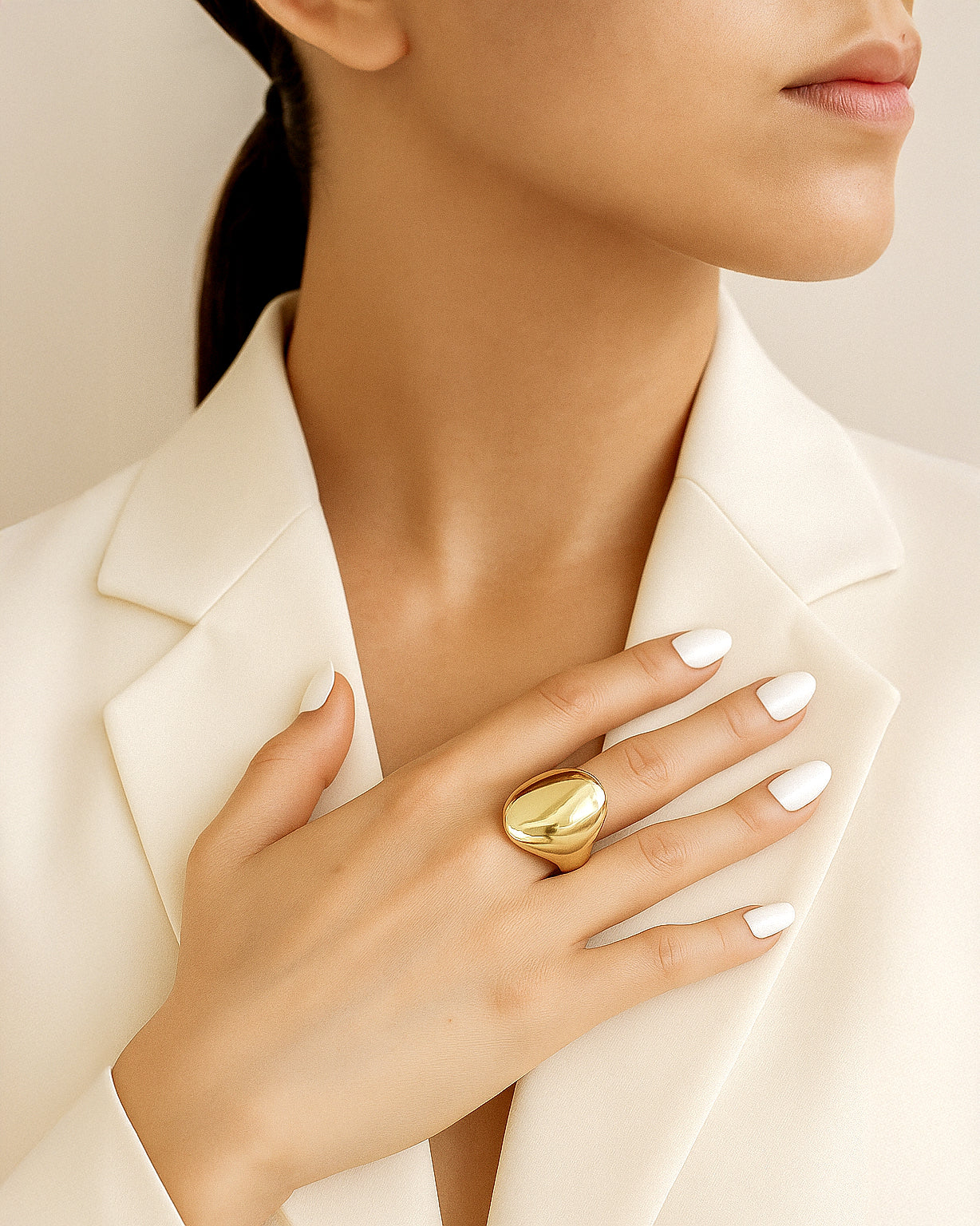 Gold statement ring with bold sculptural curved surface