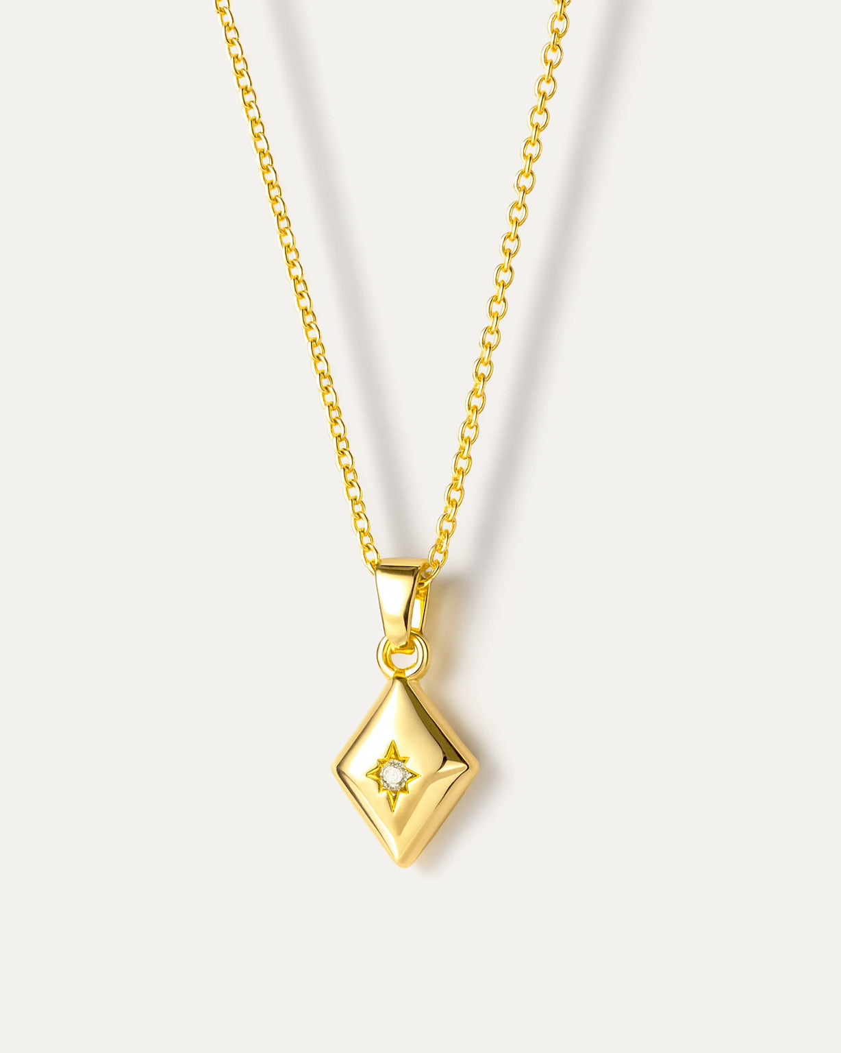 Layered necklace with natural pearl and geometric pendant, crafted from 18K gold-plated brass on neutral background