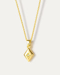 Layered necklace with natural pearl and geometric pendant, crafted from 18K gold-plated brass on neutral background
