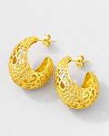 Gold-plated crescent hoop earrings with ornate baroque cutout design