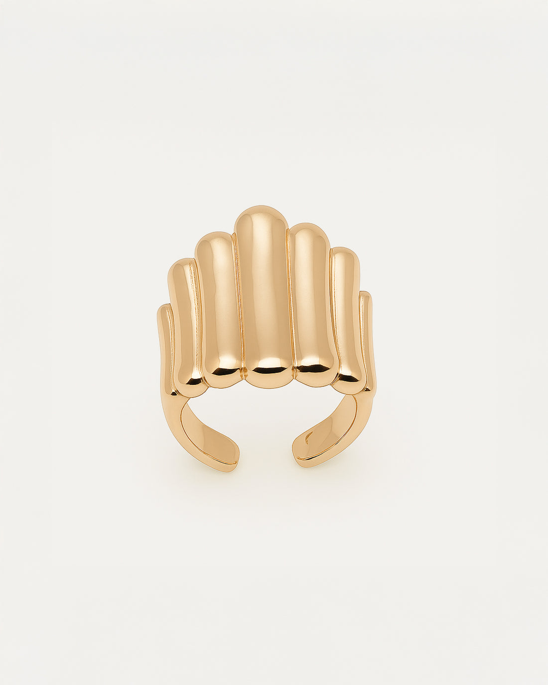 Gold statement ring with bold vertical ridges in a cascading sculptural design