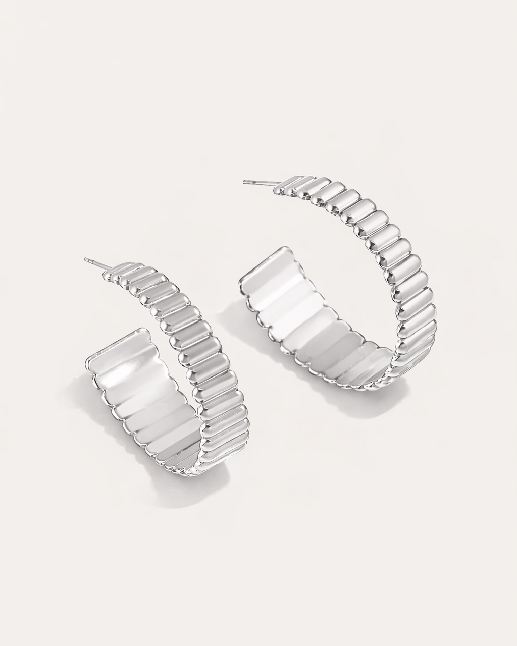 Silver ribbed hoop earrings with bold grooved texture modern design