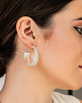 Bold Groove Hoops in silver with sculptural ridged design and half-circle shape, statement earrings from Jadejuri.
