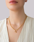 Gold shackle pendant chain necklace worn on model, featuring a chunky gold chain and minimalist shackle clasp by Jadejuri