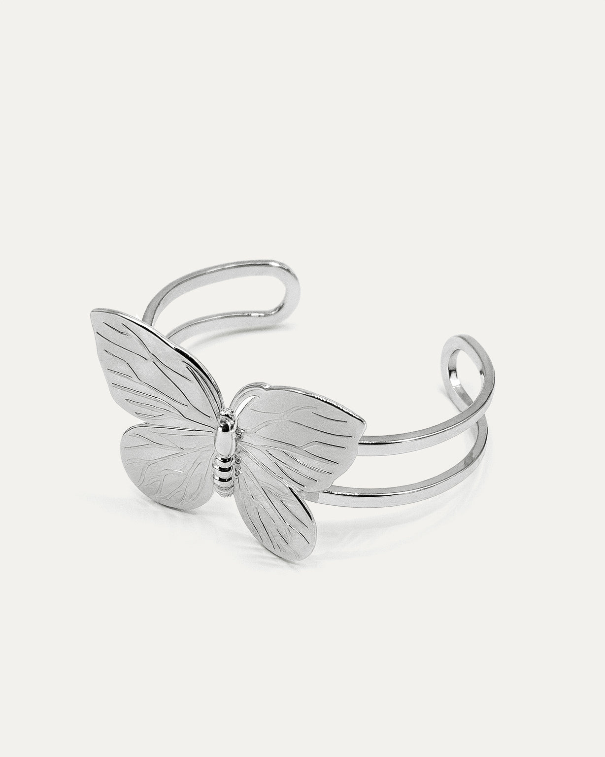 Butterfly Embrace Cuff bracelet in silver-plated brass with detailed butterfly design and open cuff structure