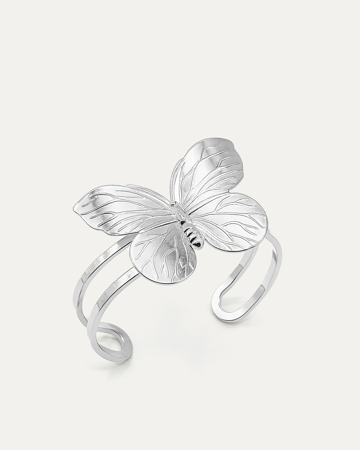 Butterfly Embrace Cuff bracelet in silver-plated brass with detailed butterfly design and open cuff structure