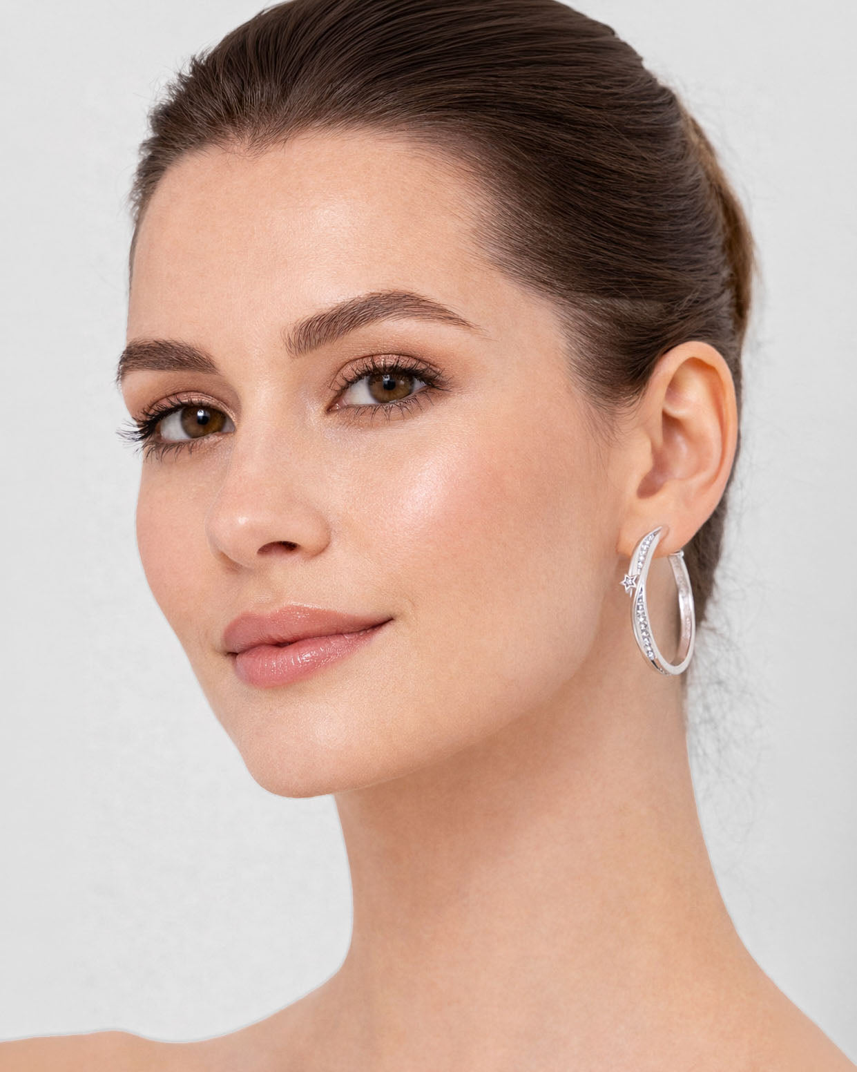 Silver star hoop earrings on ear with crystal detail minimalist jewelry