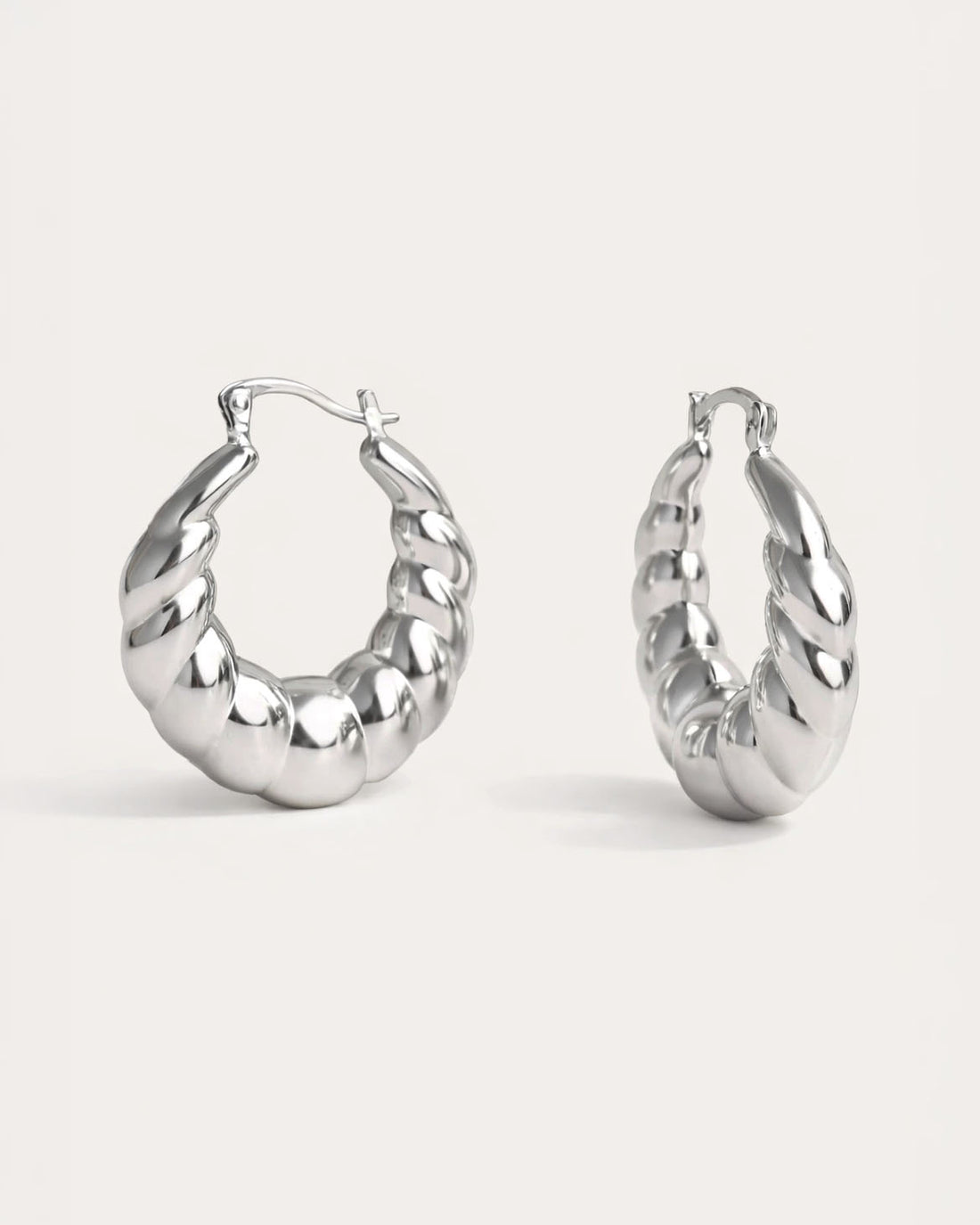 Chunky Spiral Hoops in polished silver with twisted sculptural design – Jadejuri