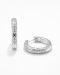 Silver pavé hoop earrings with diamond-like detailing and polished silver finish