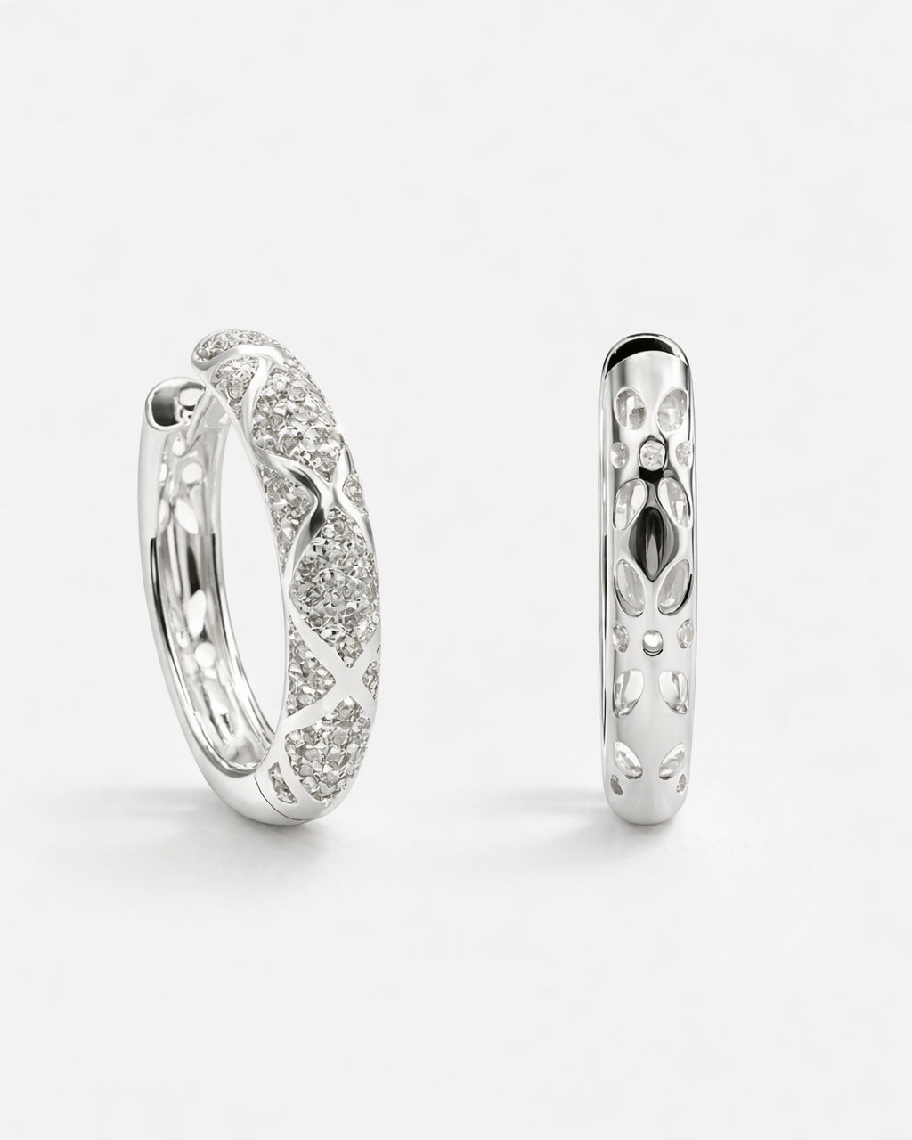 Silver pavé hoop earrings with diamond-like detailing and polished silver finish, side view