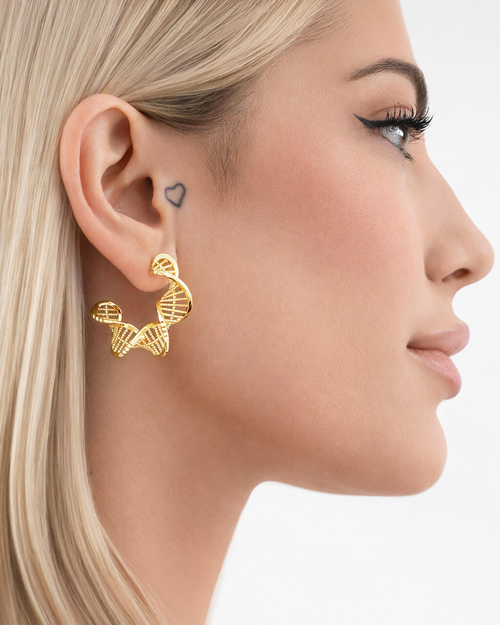 model wearing 18k gold-plated DNA helix hoop earrings, sculptural twisted hoop design, modern statement jewelry side profile