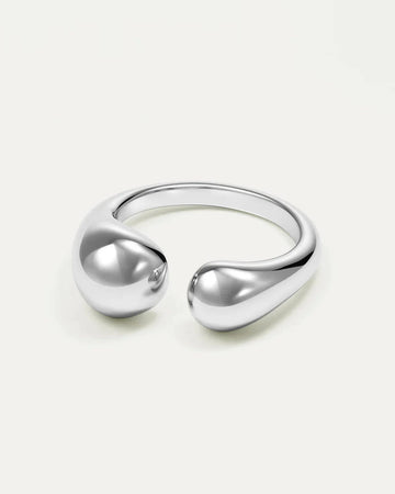 Isolated image of a polished silver-tone open cuff ring featuring a fluid, organic 'Duo Drop' design with two smooth, bulbous
