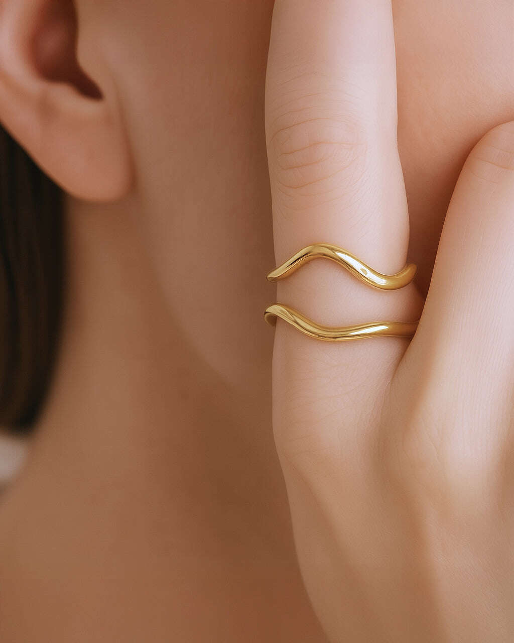Gold ring on a finger with a blurred background