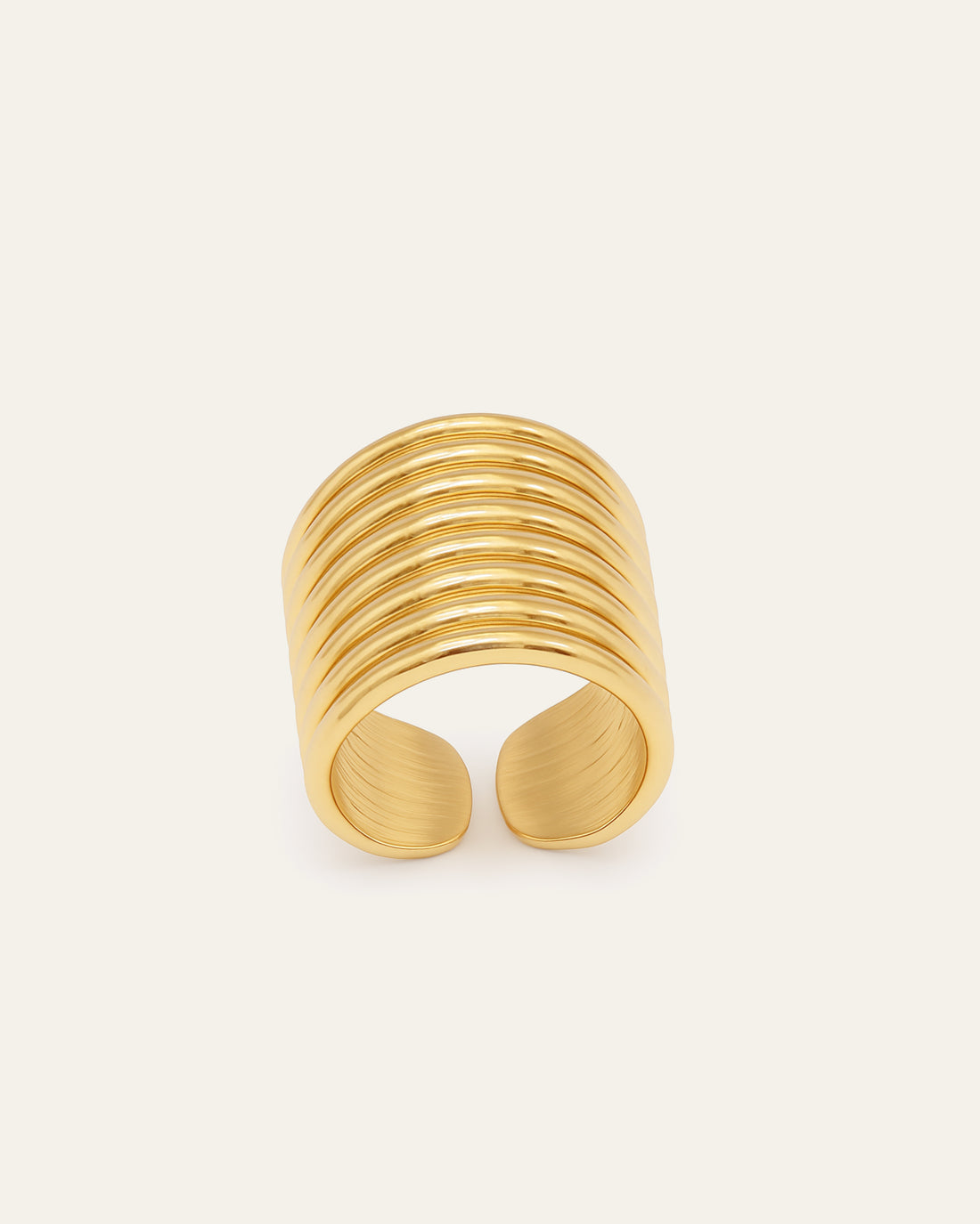 Gold statement ring with wide grooved band design