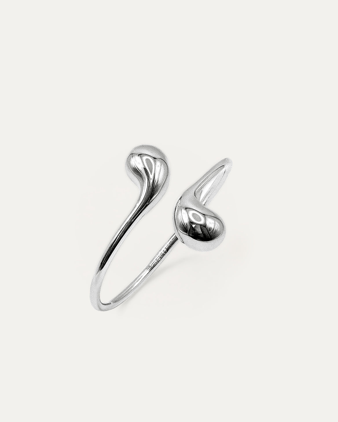 Eclipse Drop Cuff in silver-plated brass with double droplet ends and a polished sculptural finish