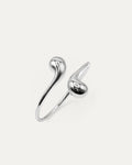 Eclipse Drop Cuff in silver-plated brass with double droplet ends and a polished sculptural finish
