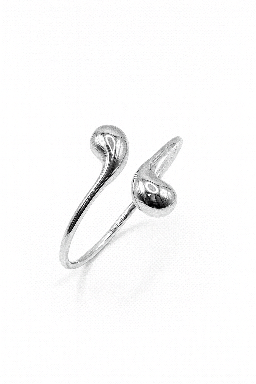 Eclipse Drop Cuff in silver-plated brass with double droplet ends and a polished sculptural finish