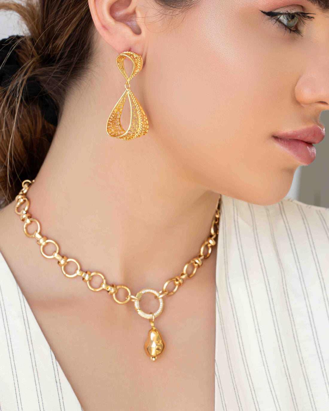 Gold filigree drop earrings with teardrop-shaped openwork design