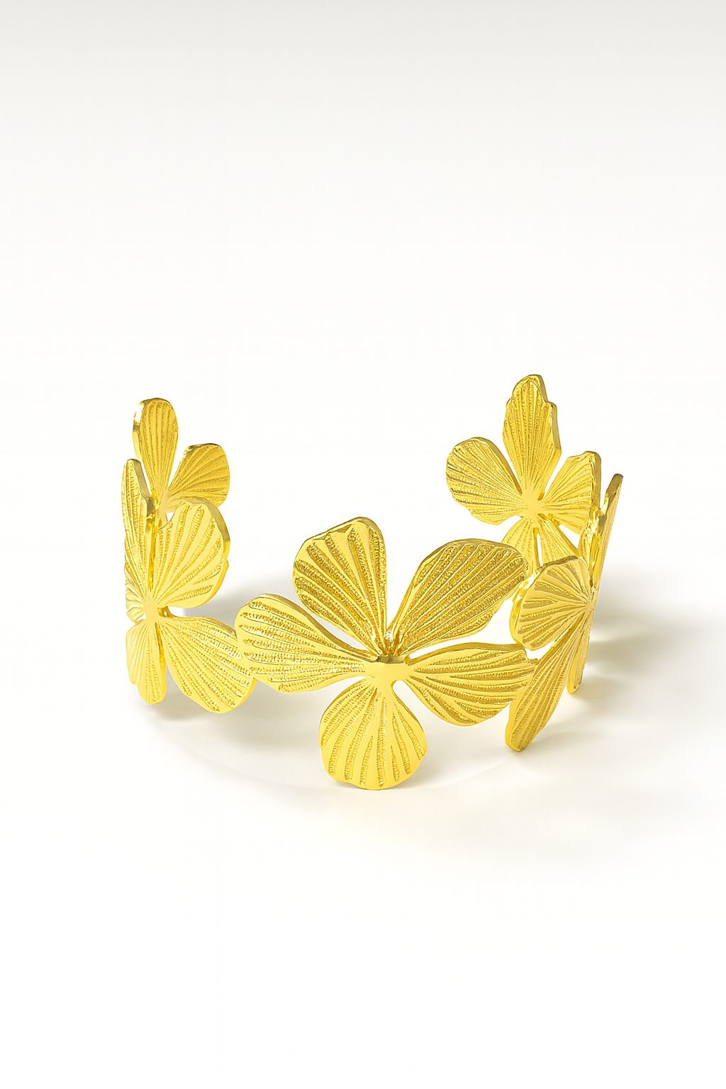 18K gold-plated brass cuff bracelet with engraved floral openwork design on white background