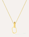Gold necklace with a unique pendant on a light gray background